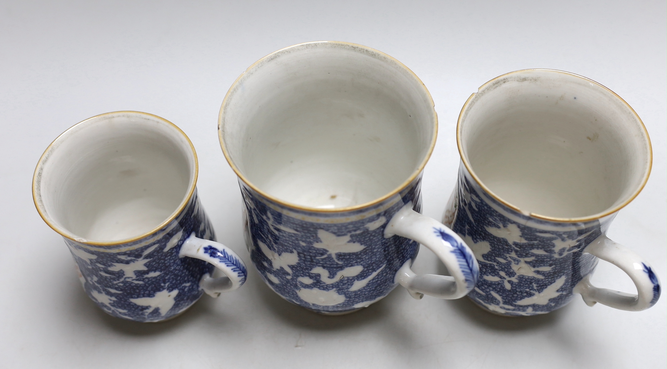 A graduated set of three Chinese mugs, Qianlong period, hand painted in the famille rose palette with figures, the largest 15cm high